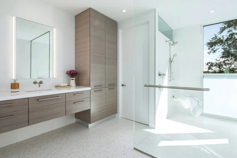 Spa-style modern bathroom with floating vanity and glass shower in luxury Longboat Key home